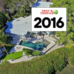 Aerial view of a coastal Sarasota home with pool, palms, and layered plantings — 2016 Troy’s Tropics design era